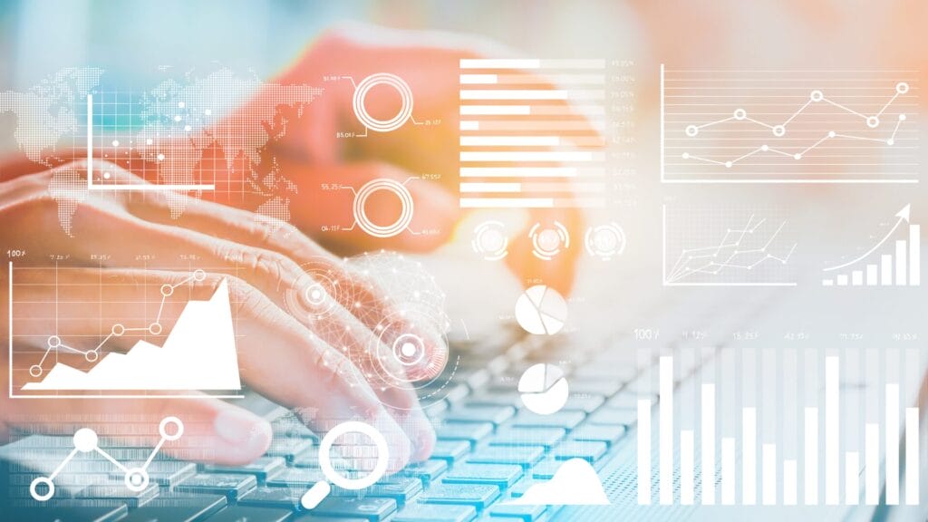 An illustrative image showing hands typing on a keyboard overlaid with graphical data visualizations, including bar charts, line graphs, pie charts, and global maps, symbolizing advanced analytics in Phrase TMS for improving business efficiency.