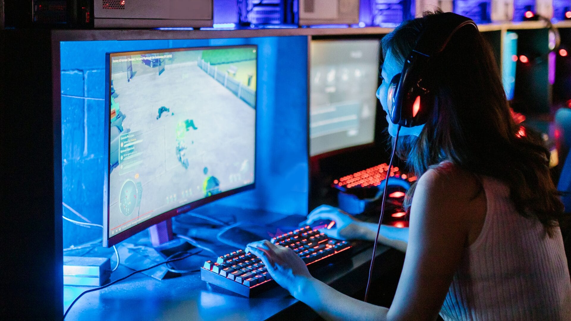 Gamer playing on a high-end PC in a neon-lit setup, wearing a headset and interacting with an AI-driven video game.