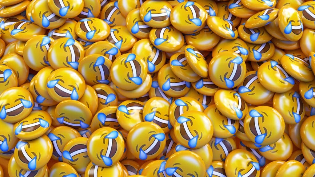 Pile of yellow "Face with Tears of Joy" emojis symbolizing emotional expression and misinterpretation in digital conversations