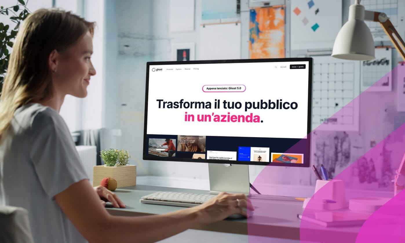 A woman at a desk viewing the Ghost website localized into Italian, with the headline "Trasforma il tuo pubblico in un'azienda", illustrating Phrase website localization in action.