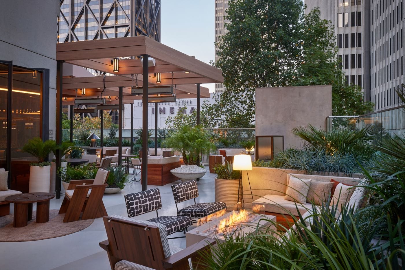 Six Park Place garden terrace with guests dining under umbrellas at dusk